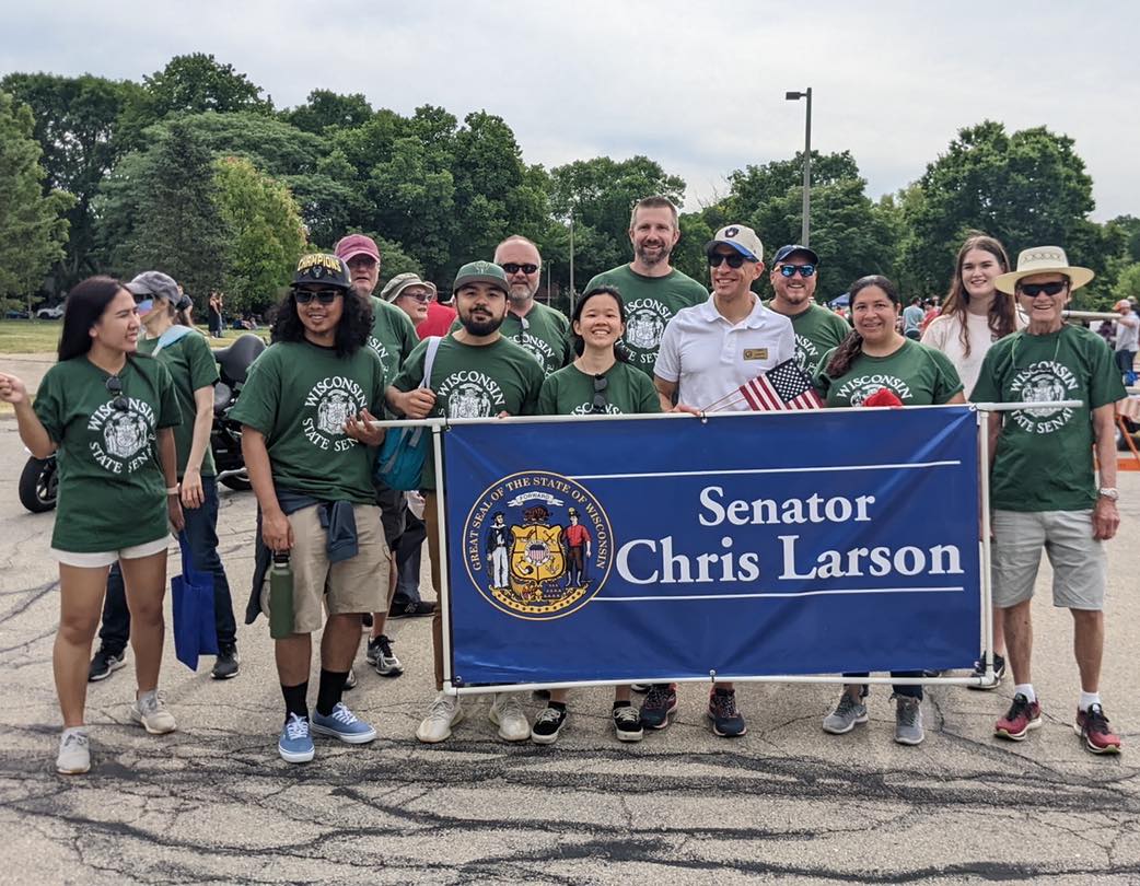 Chris Larson marching with volunteers in parade